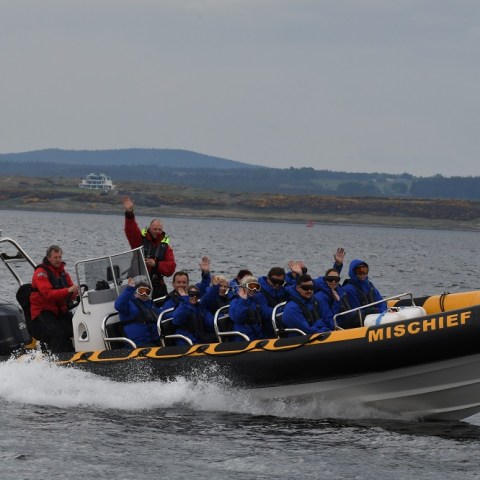 a group of people on a boat in the water